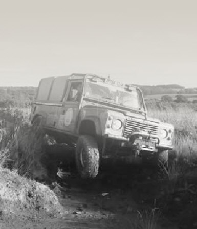 Land Rover Defender 110 with wheel in air on trial
